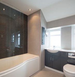 Sleek bathroom with contemporary slate-coloured fittings