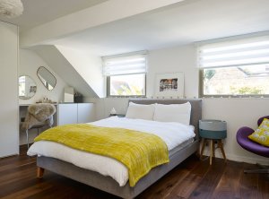 Modern, light bedroom with dormer windows