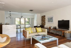 Open-plan living area with varnished floorboards