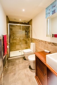 Shower room with grey tiling