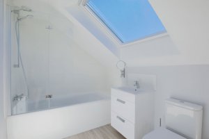 Contemporary bathroom with skylight and floating sink