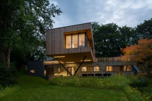 Contemporary home on stilts at dusk