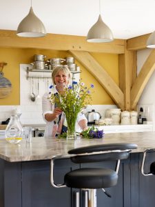 Homeowner arranging flowers in her new kitchen
