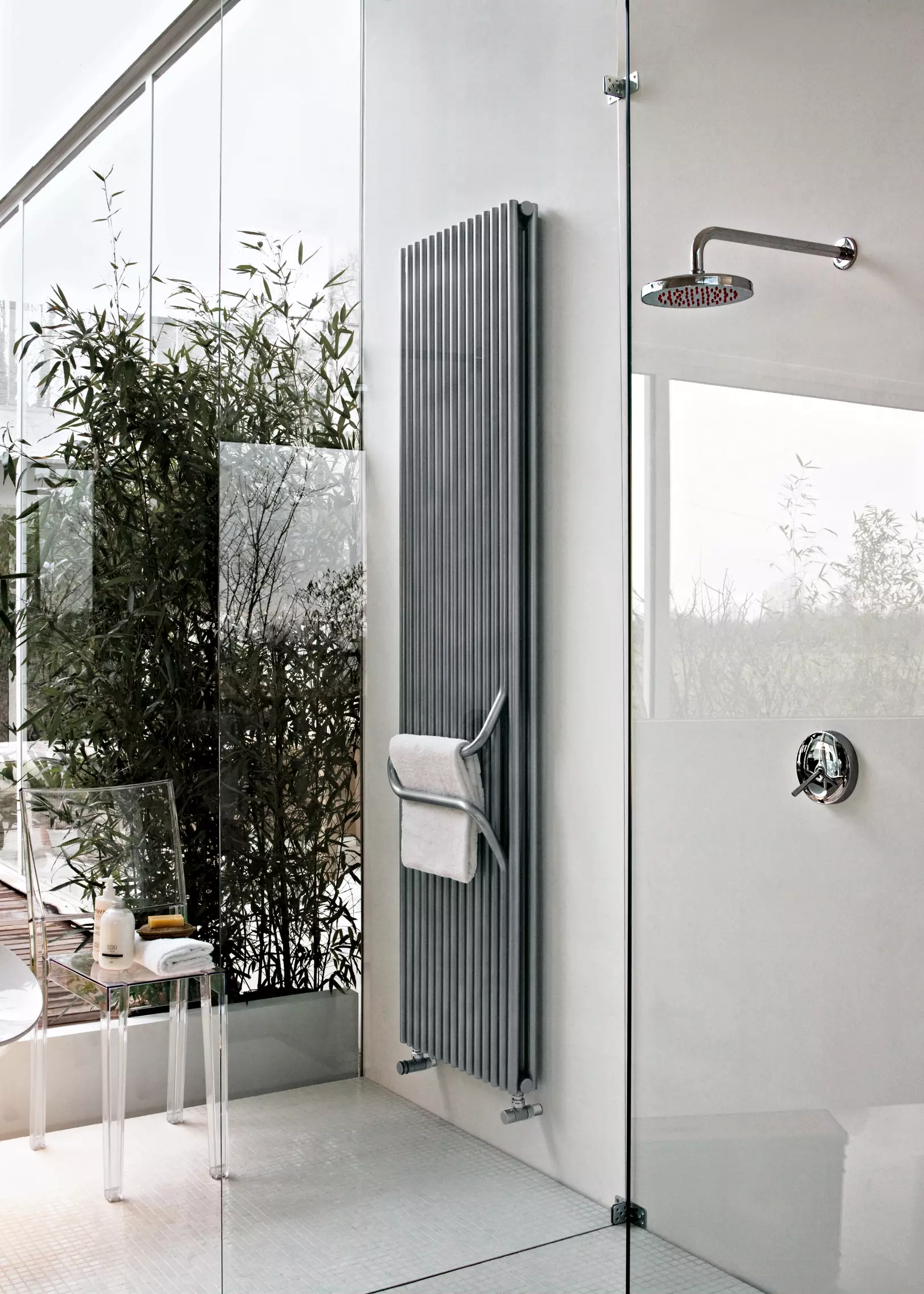 vertical steel radiator with towel rail in bathroom
