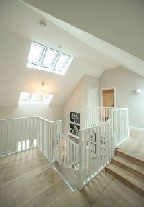Modern hallway with banisters and skylights