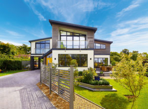 Home with white render and ash cladding