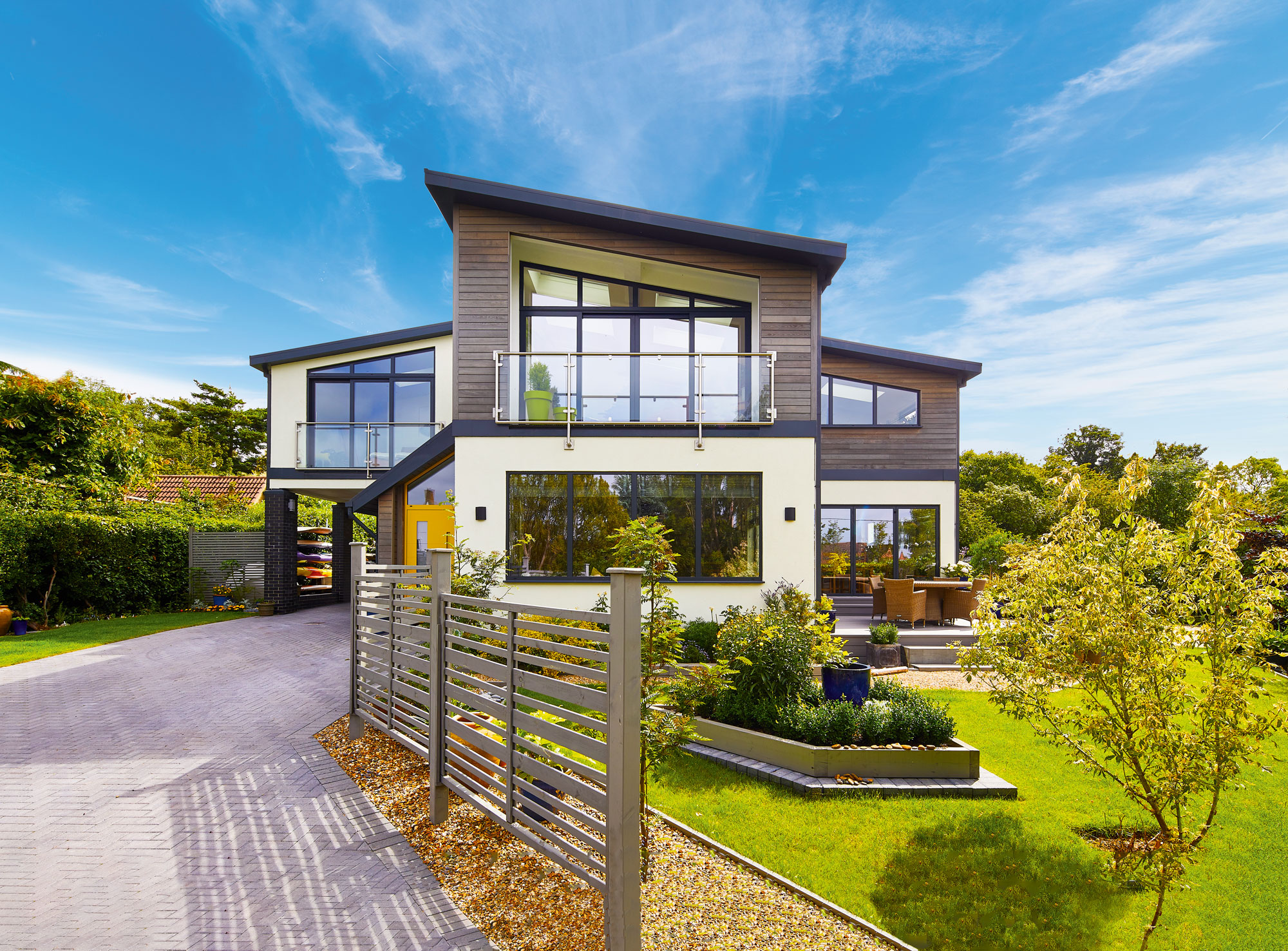 Home with white render and ash cladding