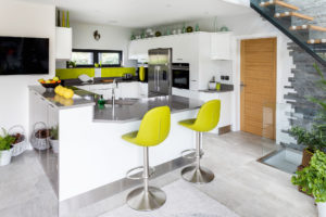 A contemporary kitchen with lime coloured splashback
