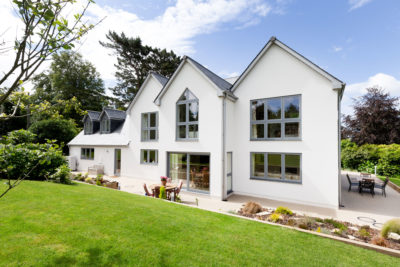 Large white house with expanse of windows