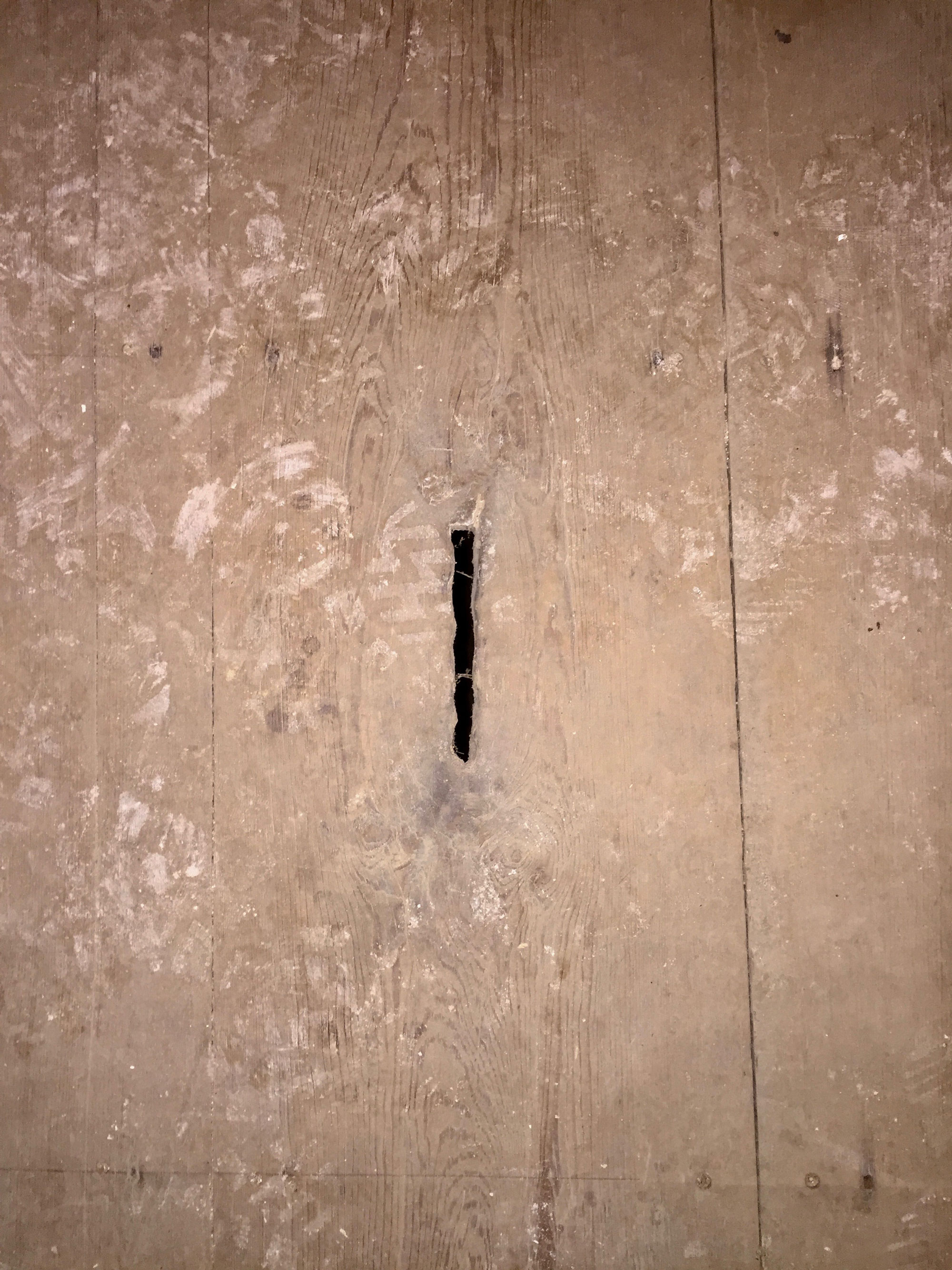 Mysterious slit in old floorboards