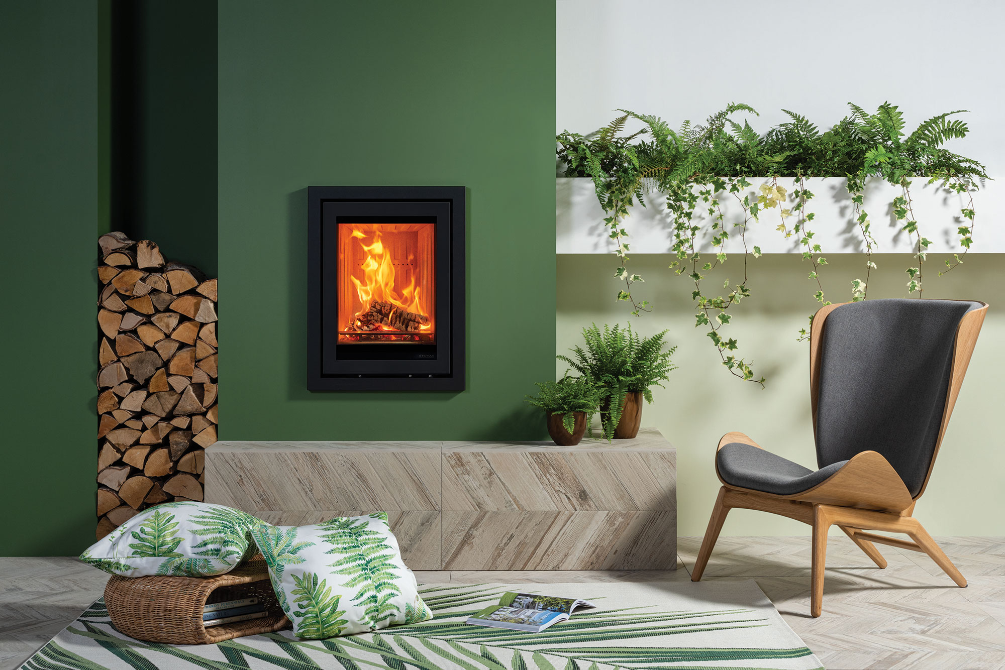 Modern stove on green wall