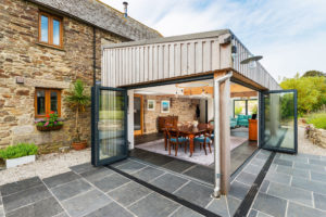 Cedar clad extension with bifold doors