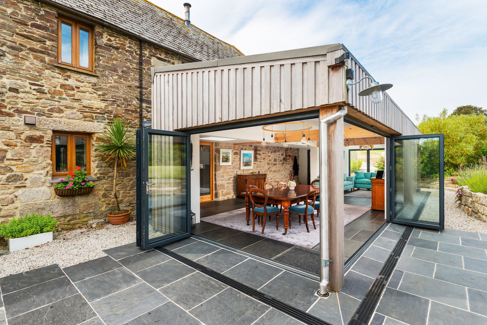 Cedar clad extension with bifold doors