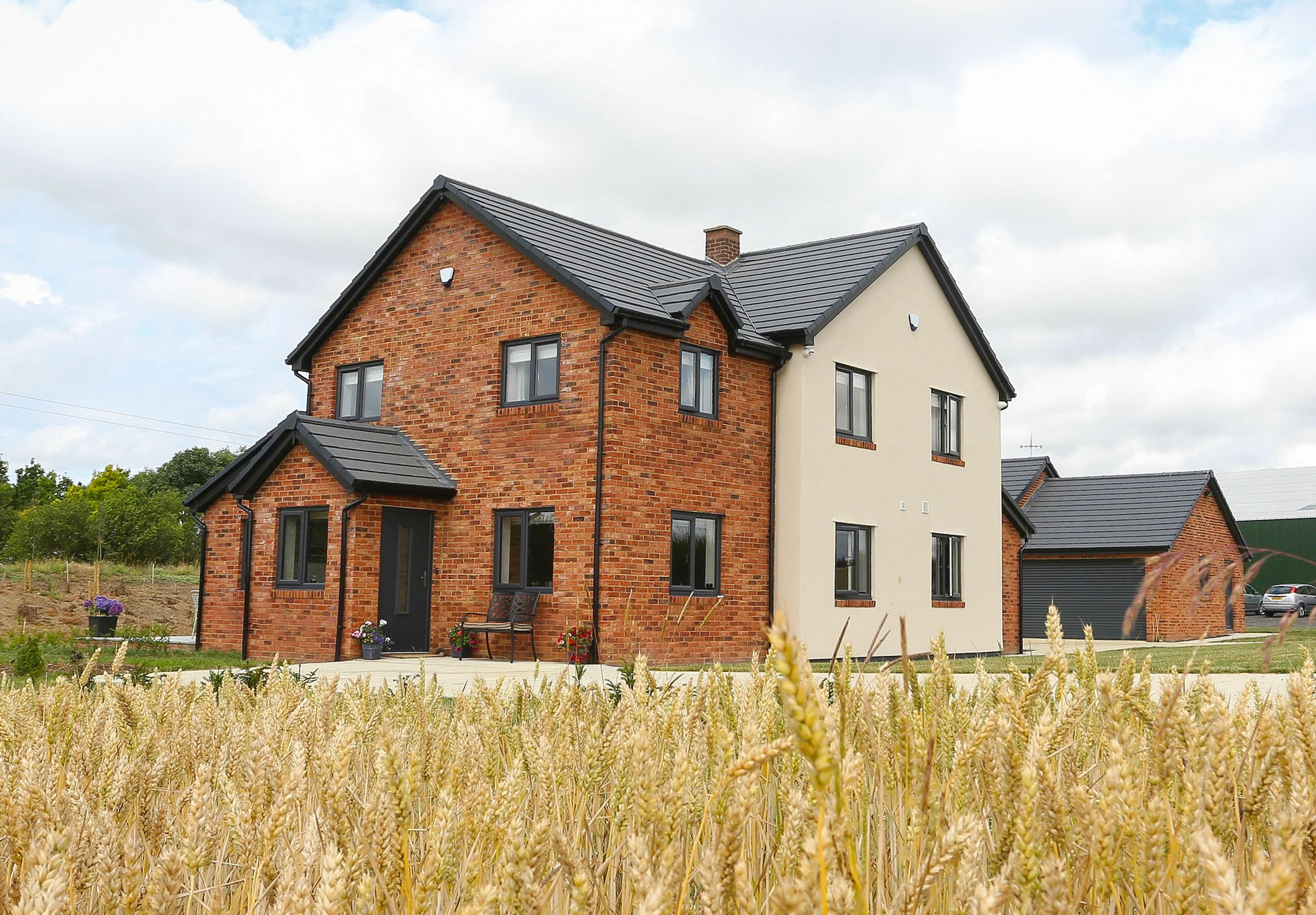 Detached red brick and render house