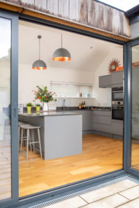 Open plan kitchen with pendent lights