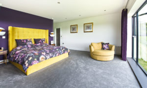 Master bedroom with yellow and purple scheme