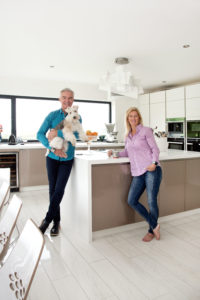 Couple stand in new contemporary kitchen