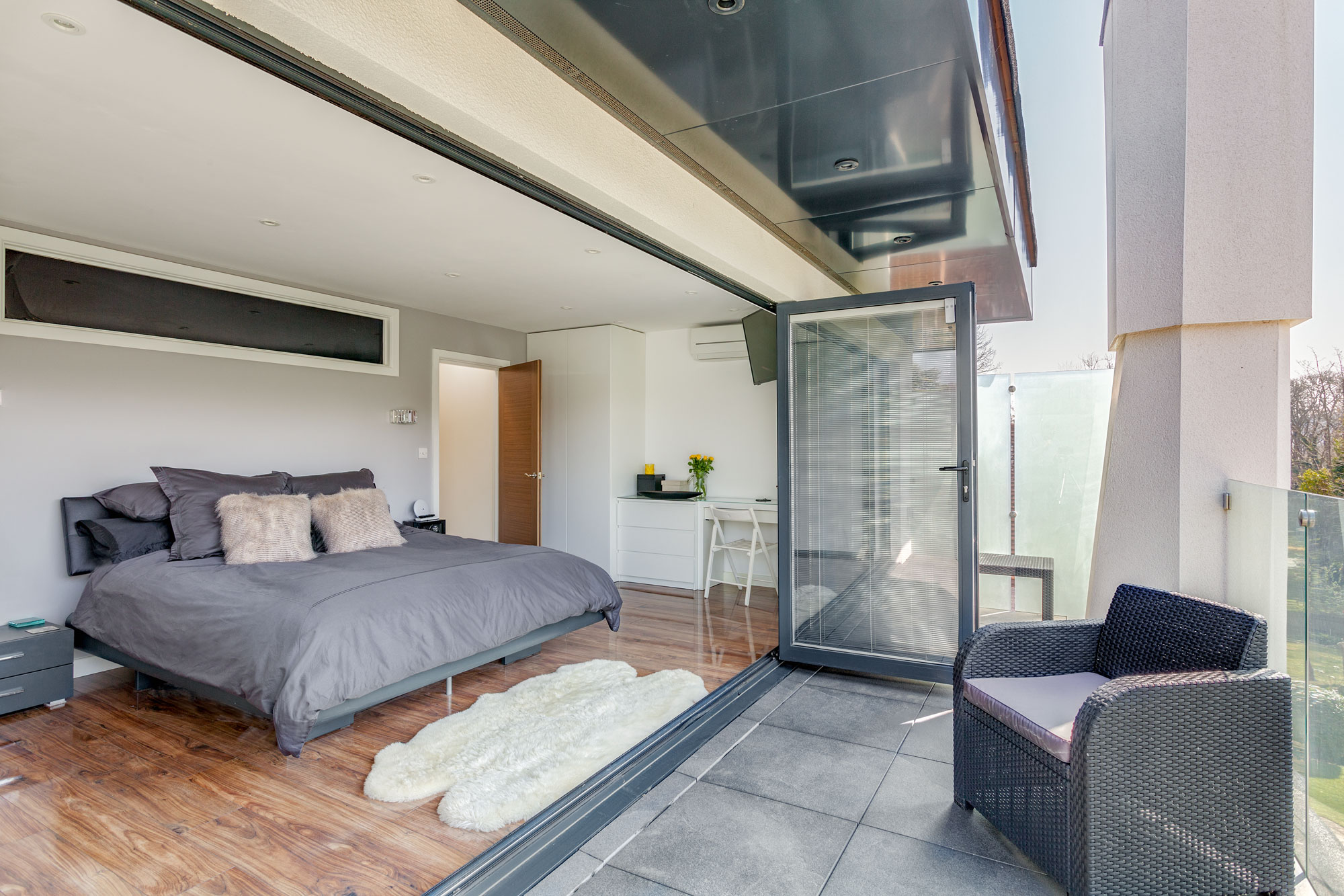Large bedroom with bifold doors in loft extension