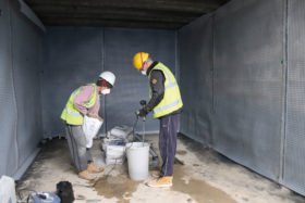 Trades people building basement