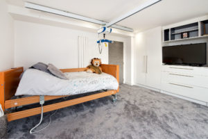Accessible bedroom with grey carpet