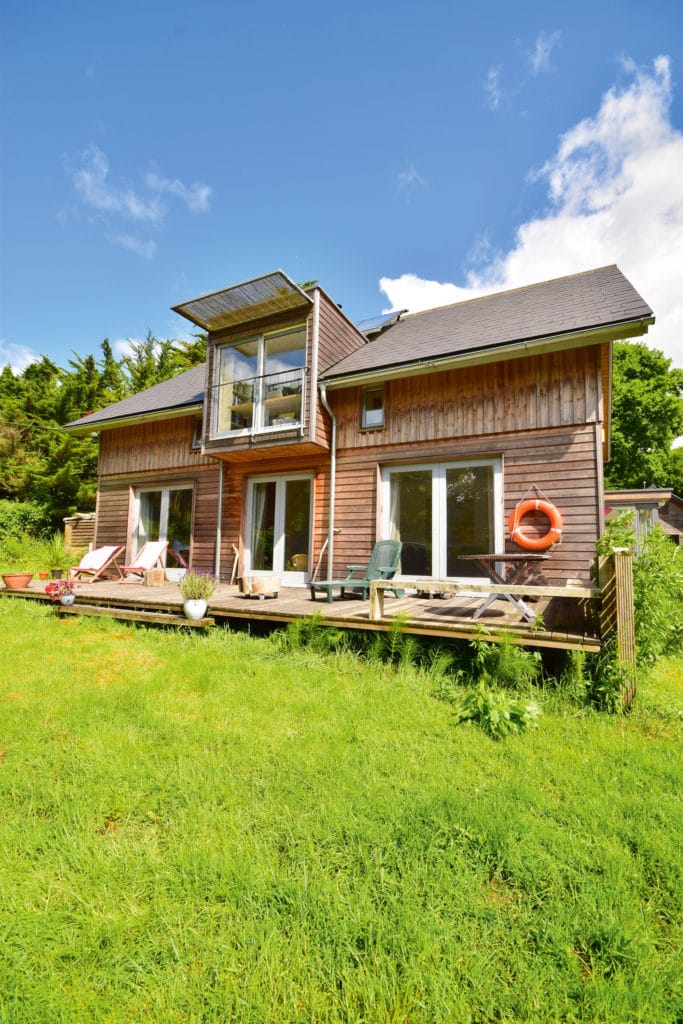 Small timber-clad structure in field