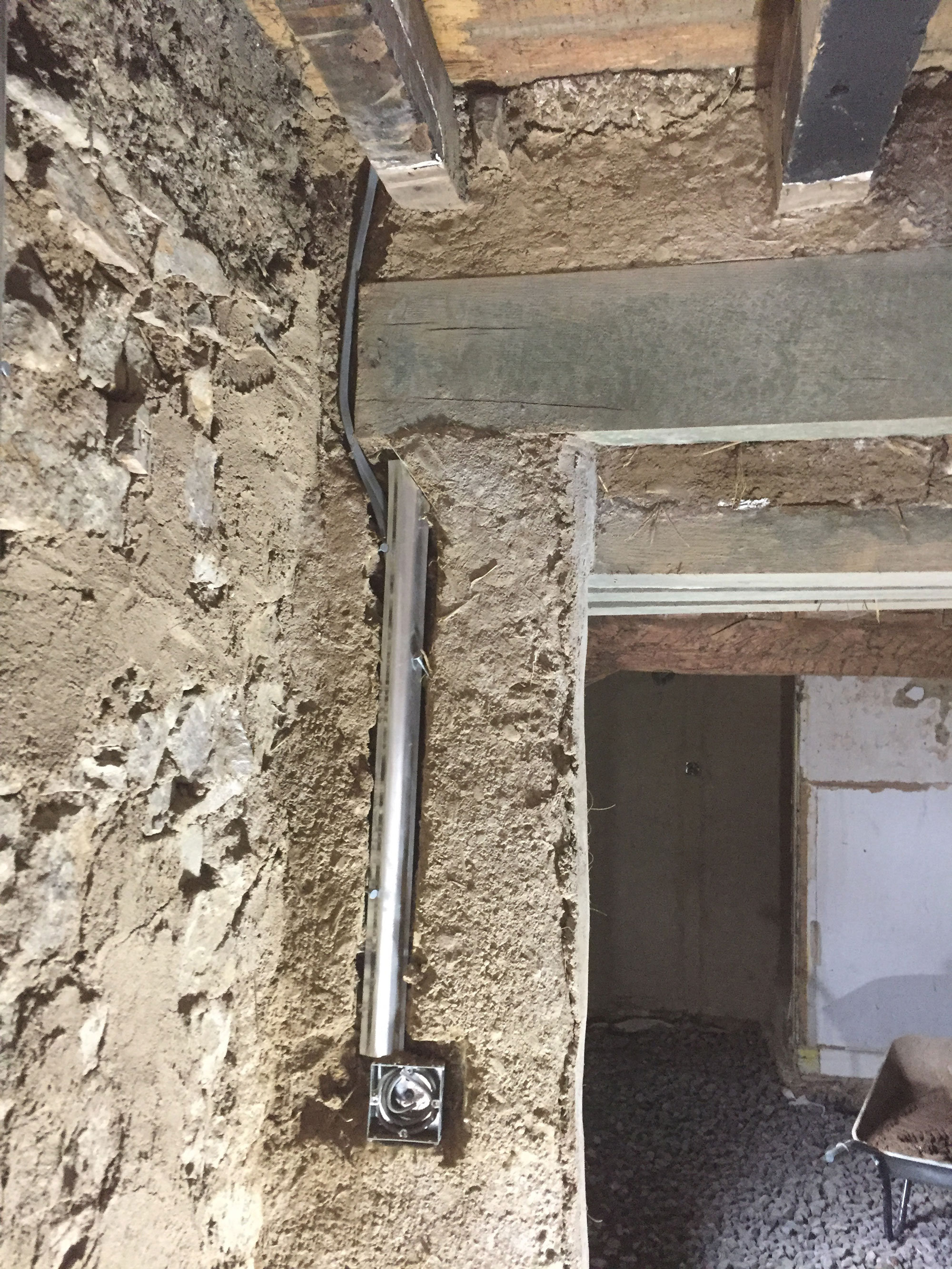 Stripped back wall with cable