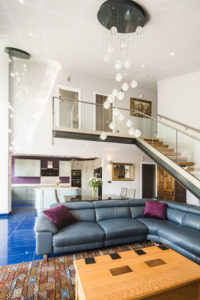 Living room with blue tiles and mezzanine