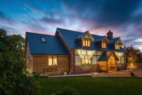 Large detached oak frame house at dusk