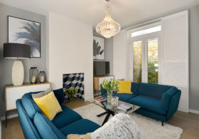 Living room renovation with blue sofas