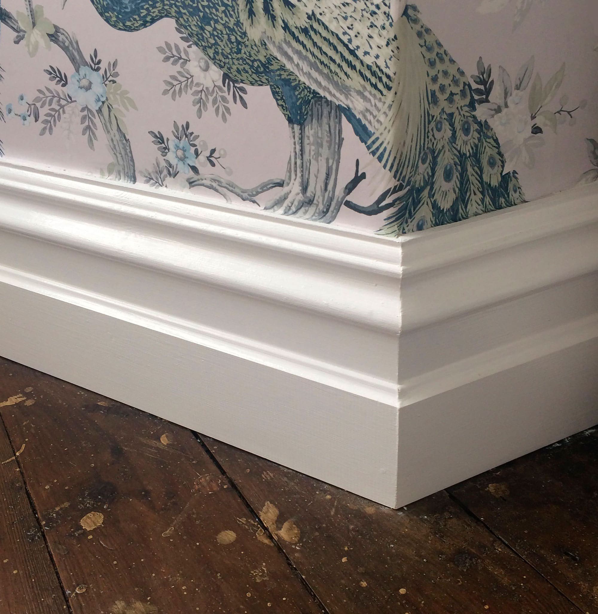 White skirting board with wallpaper