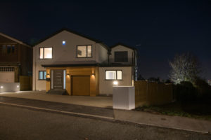 Contemporary house with front garage at night