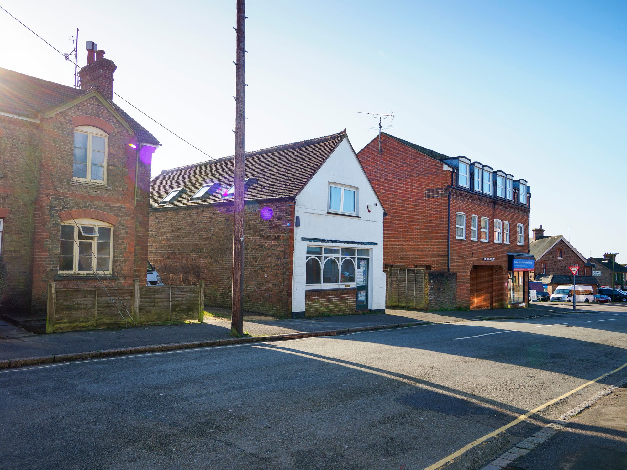 White render house on red brick road