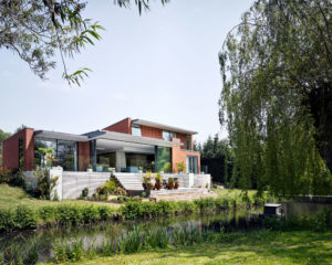 Mid century modern house with river in garden