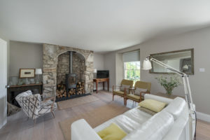 White room with stone fireplace