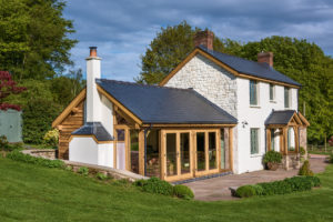 White cottage with garden room attached