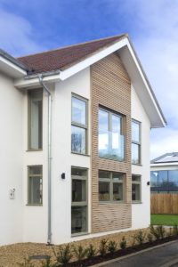 White render and timber clad house