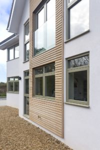 House with cladding and render