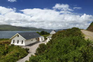 White render bungalow on coast