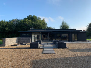 Black house with driveway