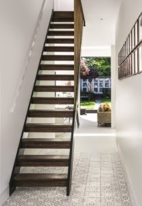 Light-filled entrance hall with modern staircase