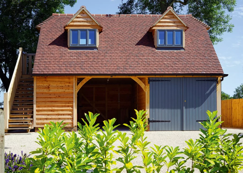 Oak double-height garage with blue doors and dormer windows