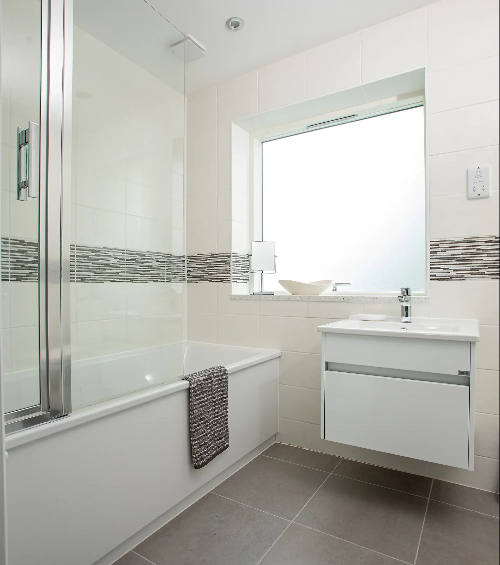 White and grey bathroom in remodelled house