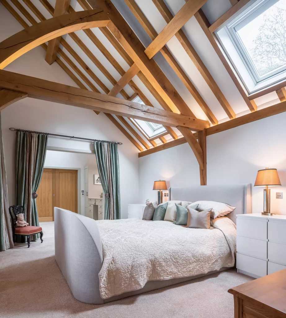 Steve and Janine Carney's oak frame annexe master bedroom leading through to a curtained dressing room and ensuite