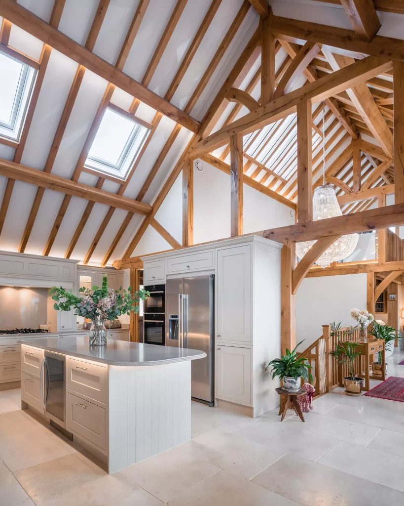 Steve and Janine Carney's oak frame annexe open-plan shaker style kitchen in pale grey and off-white, with limestone underfloor heating