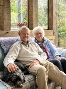 Sue and Paul Brereton with their dog in their home