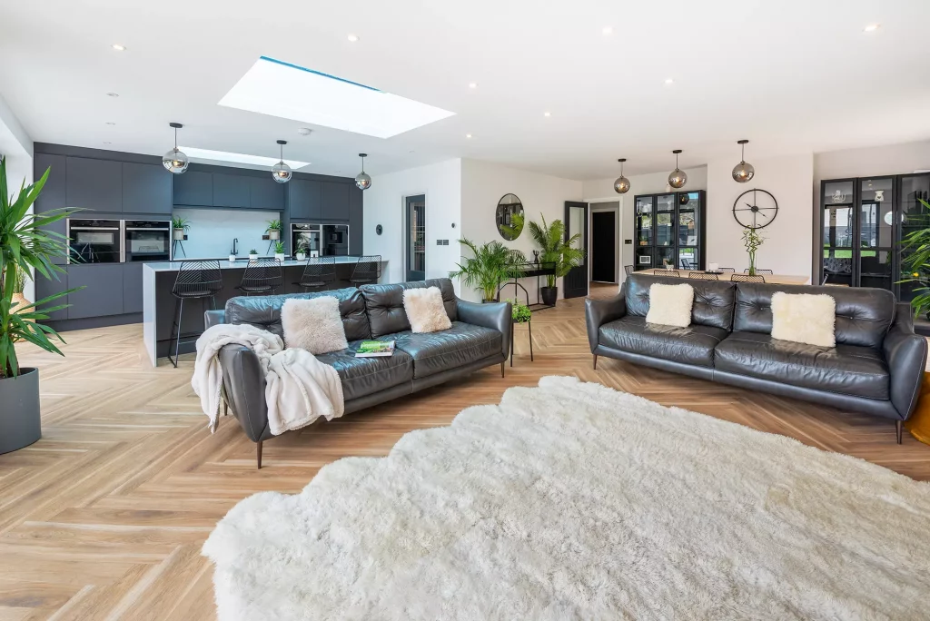 Kevin and Gemma Manning's bungalow renovation living-kitchen-dining area in a grey and white theme with herringbone wooden flooring