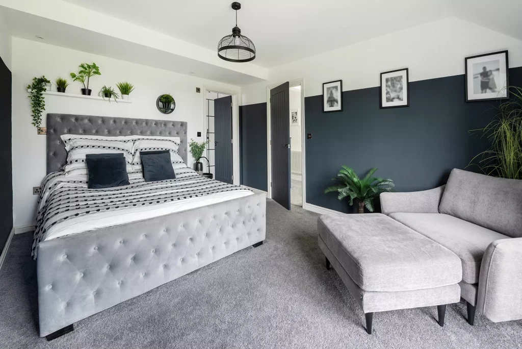 Kevin and Gemma Manning's master bedroom with grey textile features and dark grey half painted walls