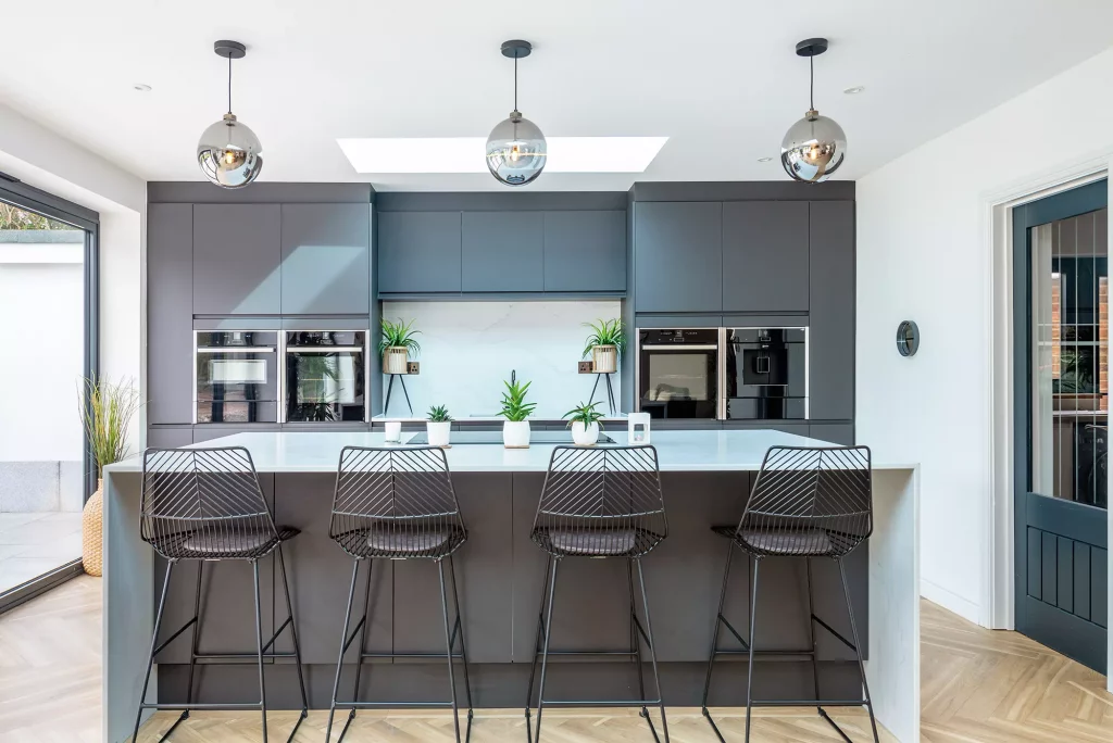 Kevin and Gemma Manning's bungalow renovation kitchen complete with grey floor to ceiling cabinets, kitchen island and bar stool seating area