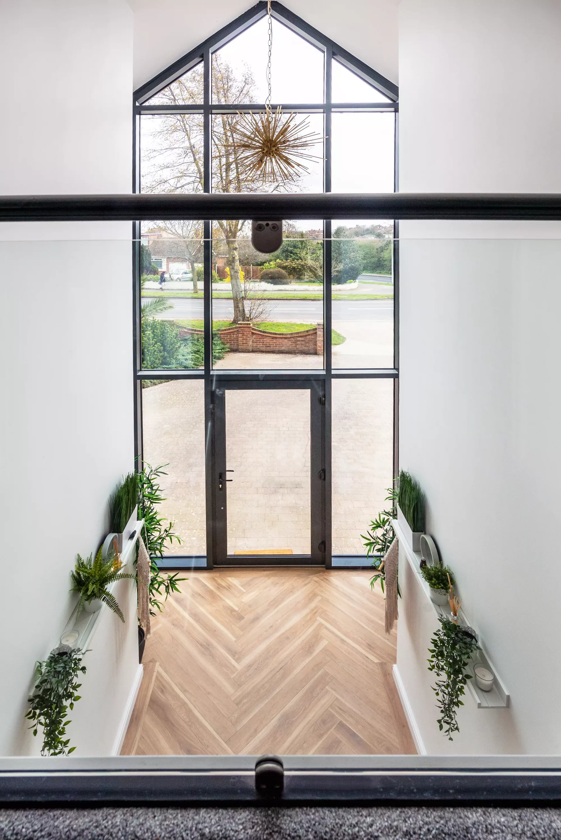 Kevin and Gemma Manning's bungalow renovation view from the landing, showing the double height window at the front door