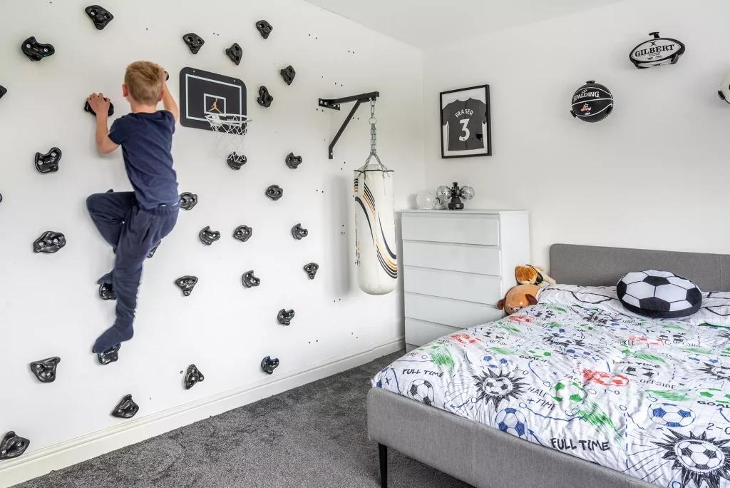 The Manning's six-year-old son plays on his bedroom's climbing wall, installed by Kevin himself